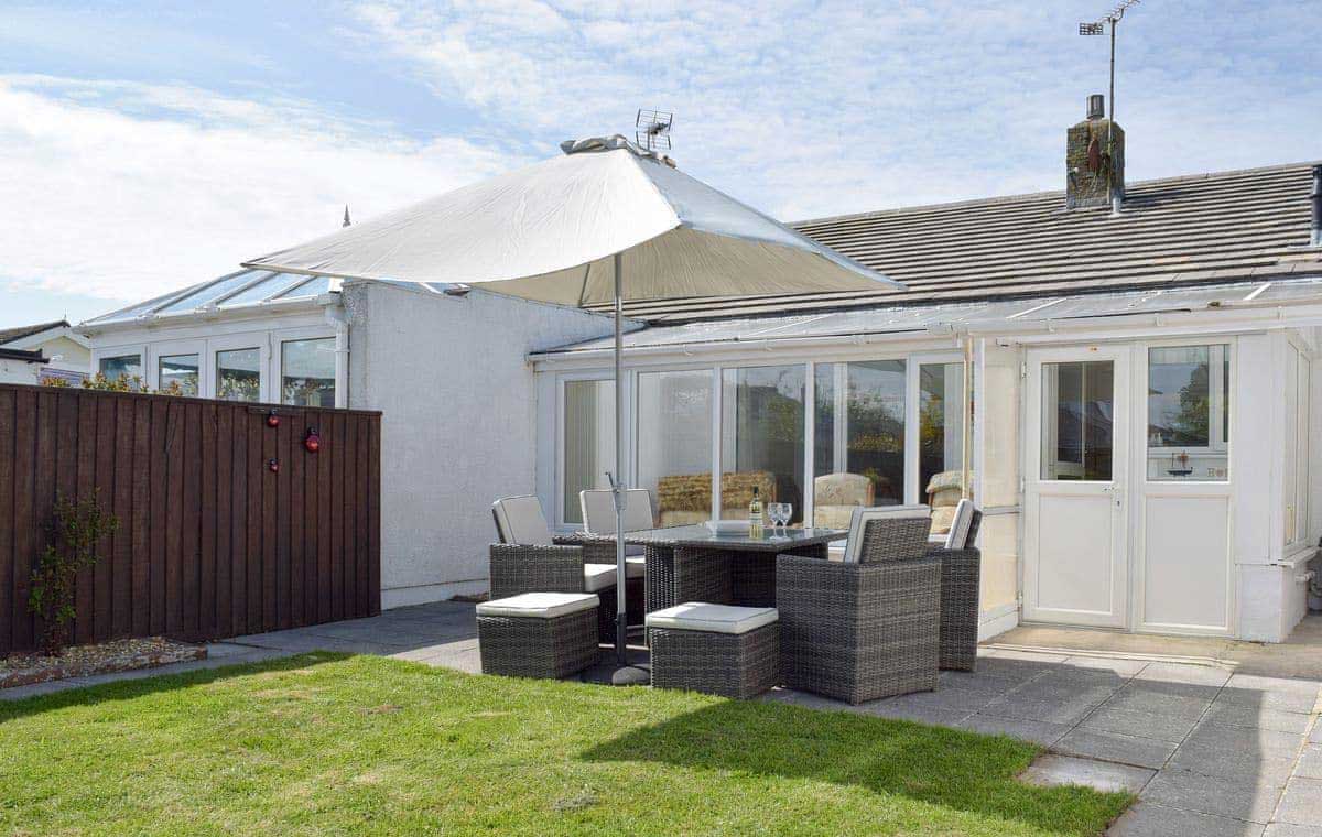 Rear garden, patio and conservatory at Sea Dreams, Saundersfoot