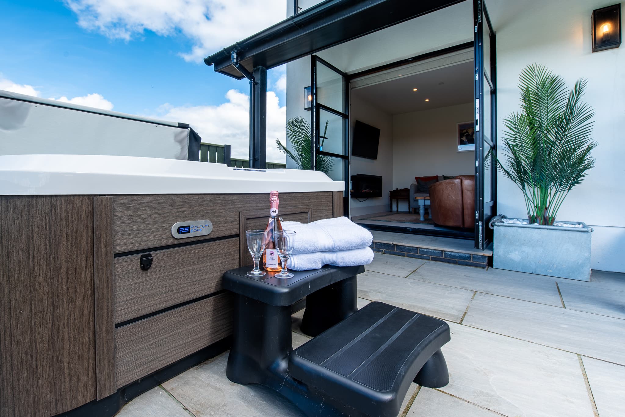Hot tub and outdoor seating in the garden at Just a Cottage