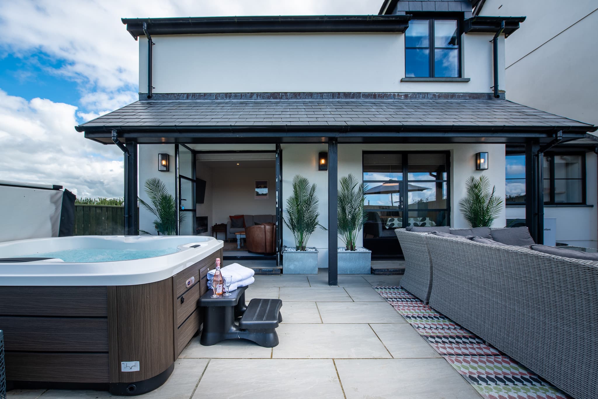 Covered patio and hot tub at Just a Cottage