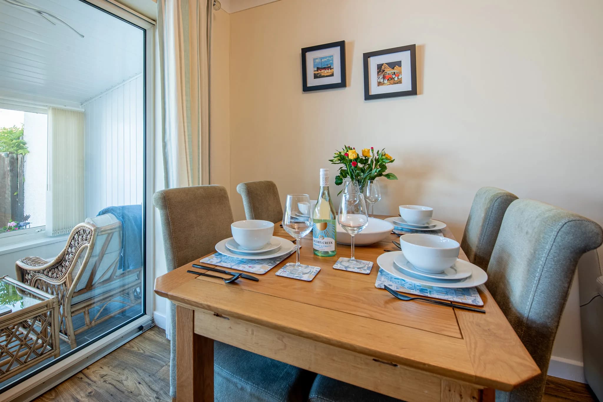 Dining table for four beside the porch at Sea Dreams
