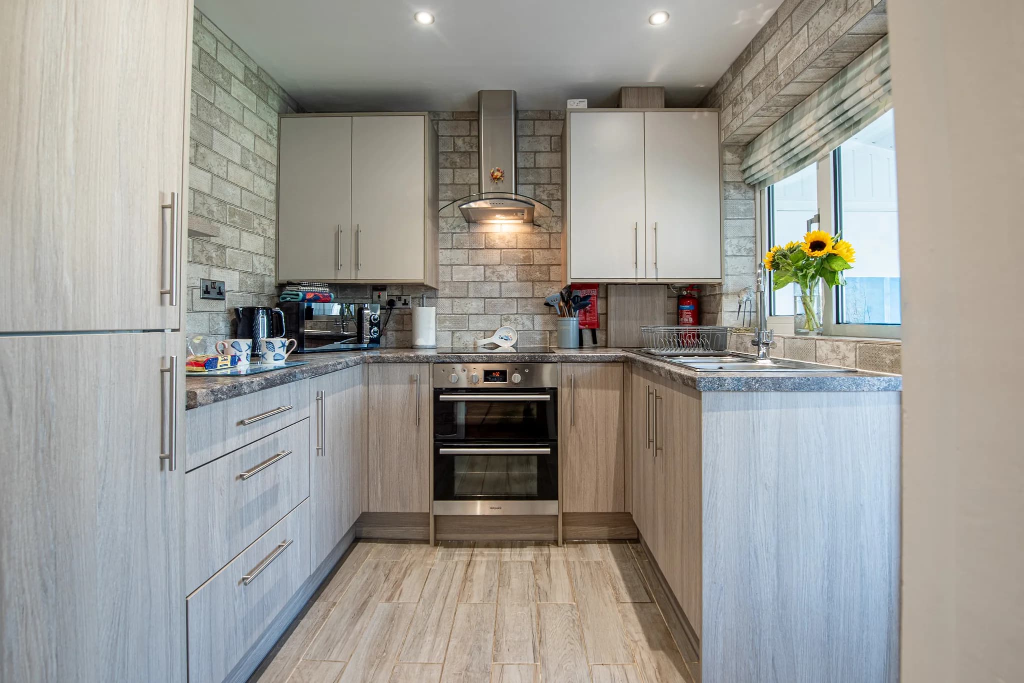 Fitted kitchen with oven and hob at Sea Dreams