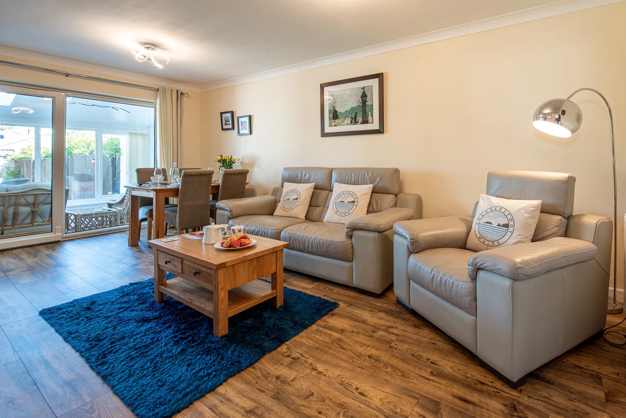 Living room with leather sofas and patio doors at Sea Dreams